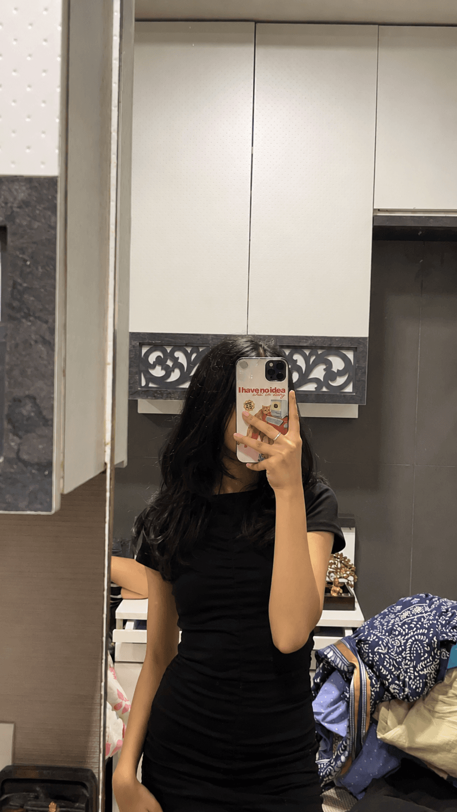 Mirror selfie featuring a funny typography phone case with a black fitted outfit.